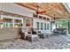 Outdoor covered patio with comfortable seating, ceiling fans, and views of the backyard at 3651 Walden Pond Dr, Sarasota, FL 34240