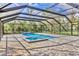 A beautiful enclosed in-ground pool and jacuzzi offer a private backyard retreat for relaxation and recreation at 3651 Walden Pond Dr, Sarasota, FL 34240