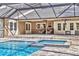 Resort-style pool and spa under a screened enclosure, perfect for relaxation and entertaining at 3651 Walden Pond Dr, Sarasota, FL 34240