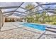 Enclosed swimming pool with brick-paved patio and spa provides an ideal outdoor living space at 3651 Walden Pond Dr, Sarasota, FL 34240
