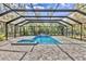 A beautiful enclosed in-ground pool and jacuzzi offer a private backyard retreat for relaxation and recreation at 3651 Walden Pond Dr, Sarasota, FL 34240