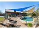 Gorgeous pool with sunshades, patio seating, bar area, and relaxing fire pit at 3951 Palau Dr, Sarasota, FL 34241