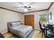Comfortable bedroom featuring a ceiling fan, light hardwood floors, and a well-sized closet at 3951 Palau Dr, Sarasota, FL 34241