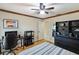 Bright bedroom with light hardwood floors, features a full workstation, and modern black shelving at 3951 Palau Dr, Sarasota, FL 34241