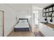 Bright bedroom features a cozy bed, wood floors, and convenient access to the bathroom and kitchenette at 3951 Palau Dr, Sarasota, FL 34241