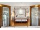 Warm bedroom featuring a four-poster bed frame and hardwood floors at 3951 Palau Dr, Sarasota, FL 34241