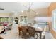 Bright dining room with modern lighting, large windows, and a view to the outdoor pool at 3951 Palau Dr, Sarasota, FL 34241