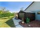 Side view of shed, with lush landscape around curved sidewalk at 3951 Palau Dr, Sarasota, FL 34241