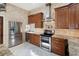 Gourmet kitchen features stainless steel appliances and custom cabinetry at 3951 Palau Dr, Sarasota, FL 34241