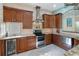 Gourmet kitchen features stainless steel appliances, custom cabinetry, and stylish stone countertops at 3951 Palau Dr, Sarasota, FL 34241