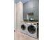 Laundry room featuring a granite countertop, gray cabinets, and washer/dryer at 3951 Palau Dr, Sarasota, FL 34241