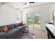 Inviting living room with natural light, a comfortable sofa, and direct access to the backyard at 3951 Palau Dr, Sarasota, FL 34241