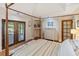 Bright main bedroom featuring a four-poster bed, wood floors, and French doors at 3951 Palau Dr, Sarasota, FL 34241