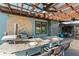 Outdoor kitchen and dining area with a pizza oven, grill, and granite countertop bar with seating at 3951 Palau Dr, Sarasota, FL 34241