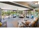 Screened patio area, with views of the pool, with comfortable seating and lighting fixtures at 3951 Palau Dr, Sarasota, FL 34241