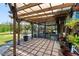 Inviting patio with pergola cover, overlooks a pool and has decorative plants around the perimeter at 3951 Palau Dr, Sarasota, FL 34241