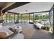 Relaxing screened patio features a variety of seating, lush greenery and views of the backyard pool at 3951 Palau Dr, Sarasota, FL 34241