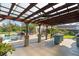 Outdoor patio with covered pergola, fan, grill, kitchen and pool at 3951 Palau Dr, Sarasota, FL 34241