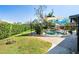 Inviting backyard pool area, shaded with awnings, surrounded by lush landscaping and ample space for relaxation at 3951 Palau Dr, Sarasota, FL 34241