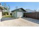 Exterior view of the green shed with closed garage door at 3951 Palau Dr, Sarasota, FL 34241