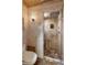 Stone tiled bathroom featuring an enclosed shower with dual showerheads at 3951 Palau Dr, Sarasota, FL 34241