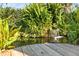 Picturesque water feature with small waterfall amid lush ferns and shrubbery at 3951 Palau Dr, Sarasota, FL 34241