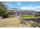 Expansive backyard with a screened-in patio and lush landscaping at 4744 Benito Ct, Lakewood Ranch, FL 34211