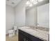 Modern bathroom featuring granite countertops, a large mirror, and updated fixtures at 4744 Benito Ct, Lakewood Ranch, FL 34211