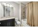 Modern bathroom with granite countertops, dual shower head, and a shower and bathtub at 4744 Benito Ct, Lakewood Ranch, FL 34211