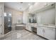 Beautiful bathroom with tiled floor, double vanity, soaking tub, and glass-enclosed shower at 4744 Benito Ct, Lakewood Ranch, FL 34211