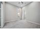 Bright bedroom with carpet floors, a window with curtains, and a view to a walk-in closet at 4744 Benito Ct, Lakewood Ranch, FL 34211
