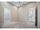 Carpeted bedroom showing closet, window, and access to a bathroom at 4744 Benito Ct, Lakewood Ranch, FL 34211