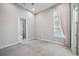 Carpeted bedroom with a window and curtains, showing access to a bathroom at 4744 Benito Ct, Lakewood Ranch, FL 34211