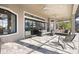 Covered patio featuring comfortable seating, ceiling fans, and stone tile flooring at 4744 Benito Ct, Lakewood Ranch, FL 34211