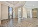 Elegant dining room featuring luxury hardwood floors, large windows and modern lighting fixture at 4744 Benito Ct, Lakewood Ranch, FL 34211