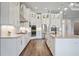Modern kitchen with stainless steel appliances, granite countertops, white cabinetry, and hardwood flooring at 4744 Benito Ct, Lakewood Ranch, FL 34211