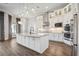 Stunning white kitchen features an island, stainless steel appliances, and modern pendant lighting at 4744 Benito Ct, Lakewood Ranch, FL 34211