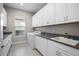 Well-equipped laundry room with granite countertops, ample cabinets, and a modern washer and dryer at 4744 Benito Ct, Lakewood Ranch, FL 34211