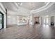 Open floorplan with wood floors featuring a kitchen, living room, and dining area at 4744 Benito Ct, Lakewood Ranch, FL 34211