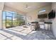 Relax in this outdoor kitchen with tile floor, ceiling fan and stainless grill at 4744 Benito Ct, Lakewood Ranch, FL 34211