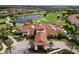Aerial view of a resort clubhouse with manicured landscaping, lush green trees and a tile roof at 4744 Benito Ct, Lakewood Ranch, FL 34211