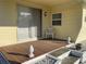 Close-up of porch, showcasing sliding glass door, chair, and outdoor decor, creating a welcoming entrance at 5319 Chateau Ln, Bradenton, FL 34207