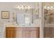 Bright bathroom featuring double sinks, tile floors, large mirror, and shower at 5684 Duval St, Bradenton, FL 34203