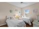 Inviting bedroom with twin beds, hardwood floors, natural light, and charming decor at 5684 Duval St, Bradenton, FL 34203