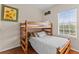 Well-lit bedroom with bunkbeds, hardwood floors, window, and decorative wall art at 5684 Duval St, Bradenton, FL 34203