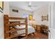 Cozy bedroom with bunk beds, wooden desk, and natural light from a window at 5684 Duval St, Bradenton, FL 34203