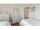 Bright bedroom with twin beds, hardwood floors, access to ensuite bathroom, and white furniture at 5684 Duval St, Bradenton, FL 34203