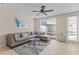 Comfortable living room with tile floors, ceiling fan, and sliding door to screened patio at 5684 Duval St, Bradenton, FL 34203