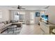 Bright living room offers ceiling fan, tile floors, sliding glass doors to patio, and a TV at 5684 Duval St, Bradenton, FL 34203