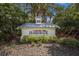 HarborAge community sign with lush tropical landscaping surrounded by mature trees at 5684 Duval St, Bradenton, FL 34203